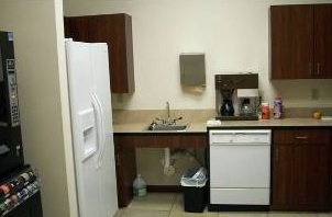 Kitchen area with fridge and coffee